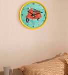 Yellow Plastic Scooting Around Modern Wall Clock